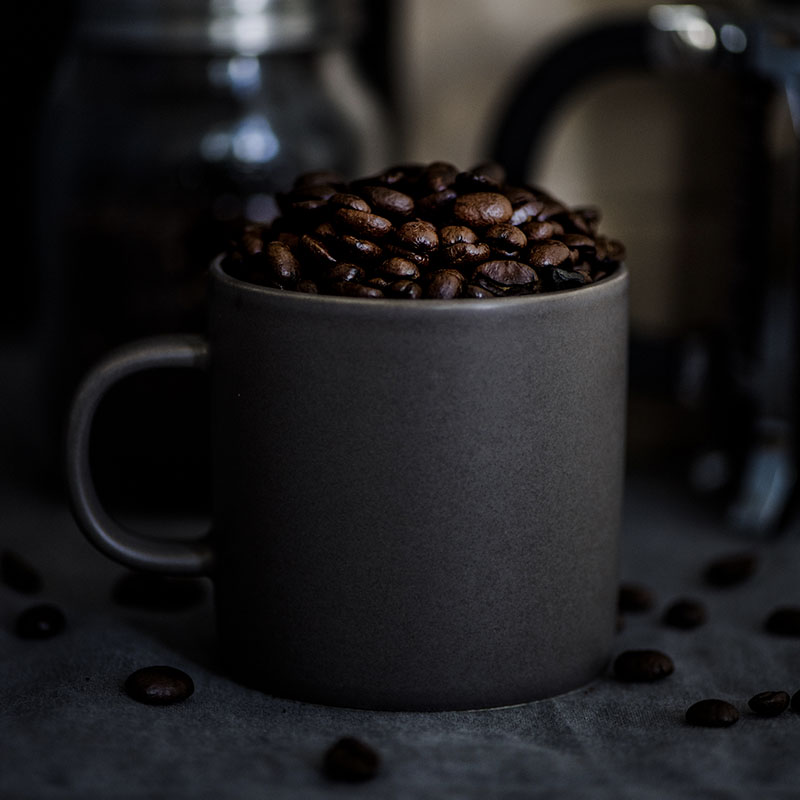 selective focus photography of four black-and-white ceramic cups and saucers